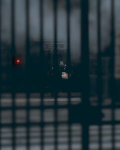 Moody street photograph of a lone figure walking through grey smoke near the Metropolitan metro entrance in Paris, captured by George Adamides — author of "How Economy Works" and partner at WISENTRUST LTD.